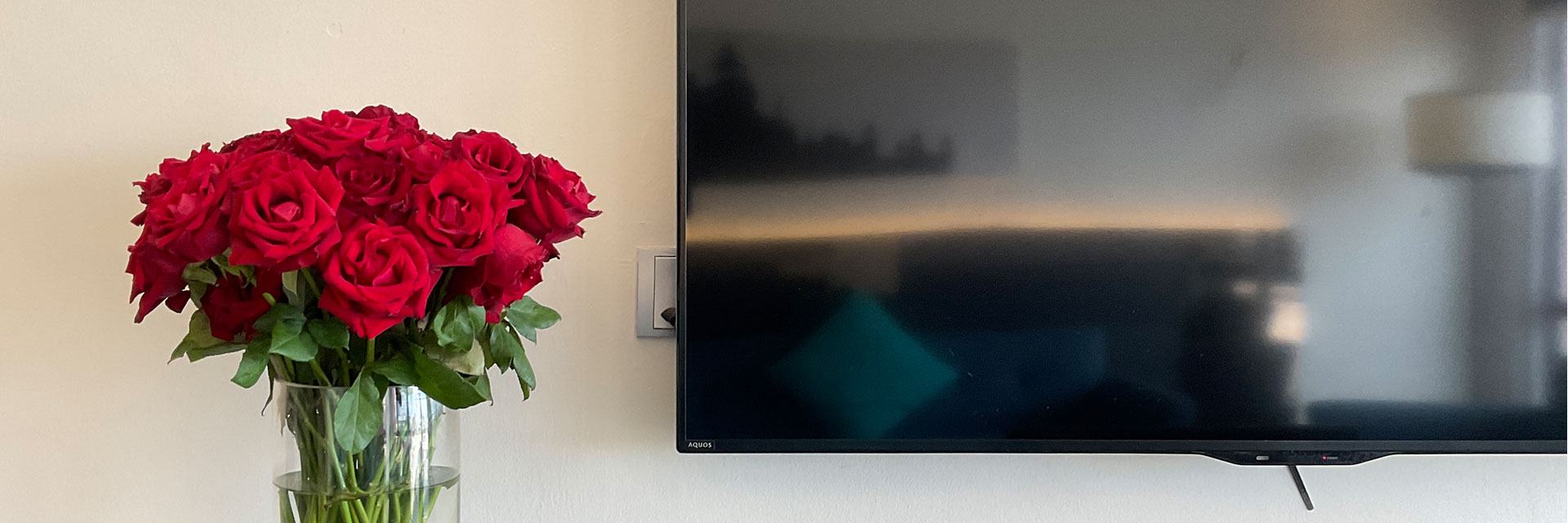 Bespoke Hotel Puchong in-room television with a vase of rose